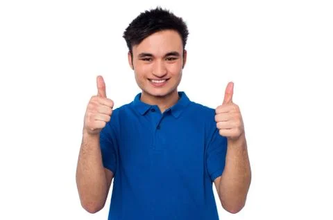 Young casual guy gesturing double thumbs up Stock Photos