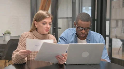Young Casual People Doing Paperwork and using Laptop Stock Footage 302874265