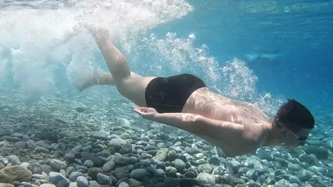 Young caucasian boy diving under into sea Stock Footage 201946276