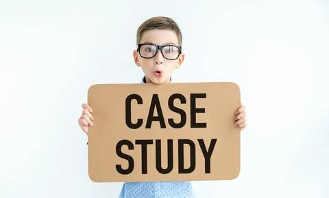Young caucasian boy smiling while holding a card with text CASE STUDY on a .. Stock Photos