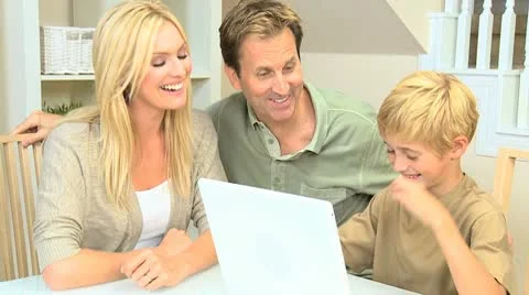 Young Caucasian Boy Using Laptop with Parents Stock Footage 8987519