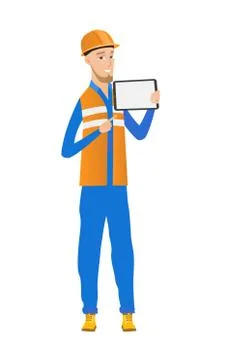 Young caucasian builder holding tablet computer. Ilustración de archivo
