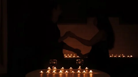 Young caucasian couple dancing under candle light Stock Footage 159548705