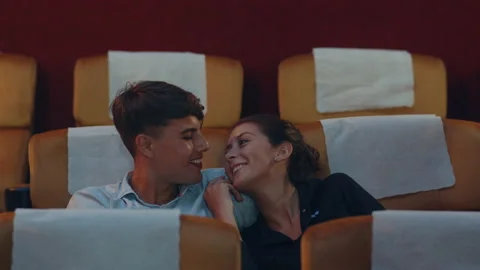 Young caucasian couple laughing while watching film in movie theater. Stock Footage 154564623