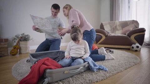 Young Caucasian couple looking at map and discussing future travel as their 動画素材 123245368