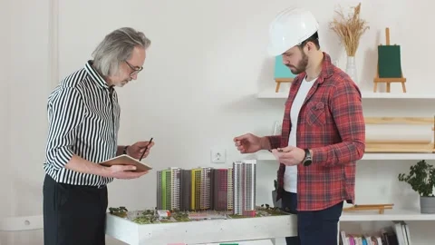 Young caucasian future foreman and professional architect co-working. Stock Footage 127038464