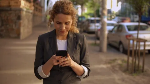 Young caucasian girl using mobile outdoors Stock Footage 90724293