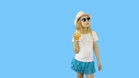 Young caucasian girl walking and drinking orange juice. Stock Footage