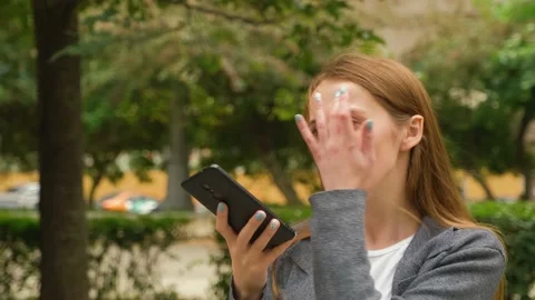 Young caucasian girl writes a voice message on her smartphone. Video stock 139911253