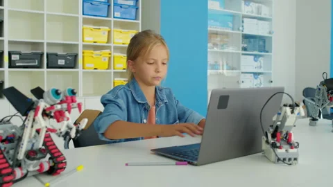 Young Caucasian Girl Writing Program for Electric Robot at Hobby Club 動画素材 244348145