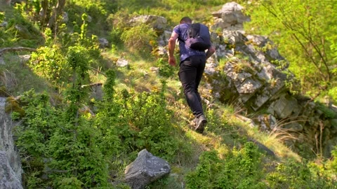 Young caucasian guy going oh a hike adventure. Male model trekking on mountain Stock Footage 132953789