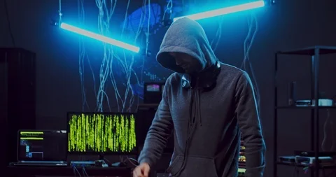 Young Caucasian guy hacker in a hood listening to the music and dancing in the Stock Footage 124352132