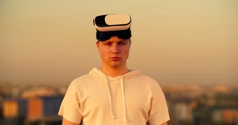 Young caucasian guy trying on vr glasses, diving into virtual reality world Video stock 120261206