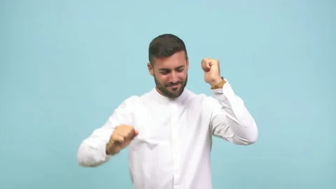 Young caucasian handsome man dancing and having fun, moving arms listening to Video stock 138665896
