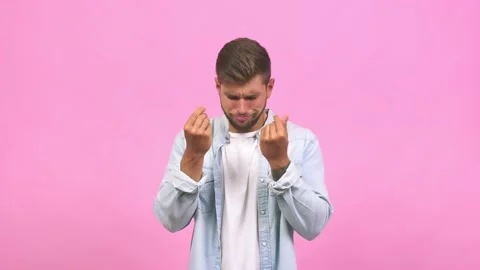 Young caucasian handsome man doing a gesture of need, restoring to charity, Stock Footage 138662142
