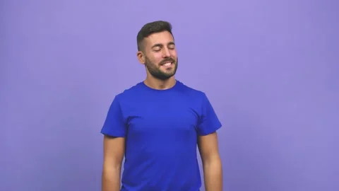 Young caucasian handsome man doing the gesture of a spyglass, is observing Stock Footage 138666377