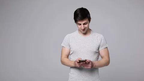 Young caucasian holding a smartphone cell in his hands Stock Footage