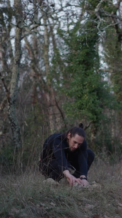 Young caucasian long-haired boy preparing the big stones for forest protection Stock Footage 276183787