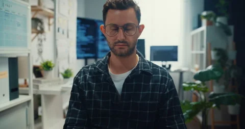 Young Caucasian male programmer writes code using multiple screens in office. Video stock 344036295