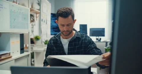 Young Caucasian male programmer writes code using computer in office. Video stock 344036558