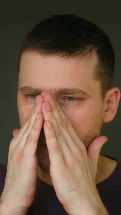 Young caucasian man applying moisturizer cream on face Stock Footage 323209530