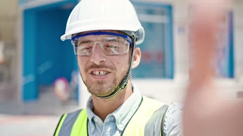 Young caucasian man architect smiling confident having video call at constr.. Stock Footage 248337333