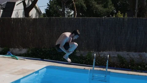 Young Caucasian man diving in the pool (slowmotion) Stock Footage