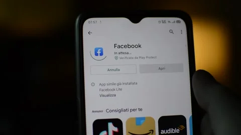 Young caucasian man download facebook app on the mobile phone Stock Footage 170537553