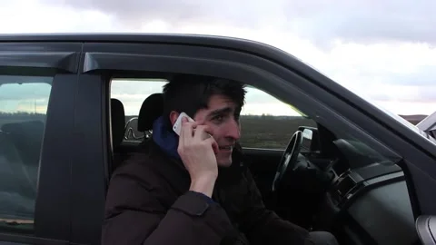 Young caucasian man express himself speaking by the phone 스톡 동영상 123725107