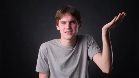 Young Caucasian Man Facepalming on black Background Stock Footage 257477809