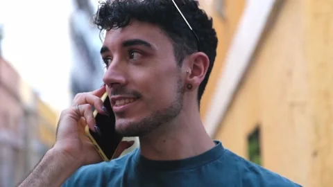 Young caucasian man with long false nails smiling and talking on the phone. Stock Footage 160157925