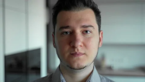 Young caucasian man looking at camera with neutral face emotion serious Stock Footage 153054651