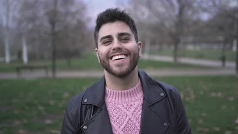 Young caucasian man looking at camera in a park Stock Footage 224111888
