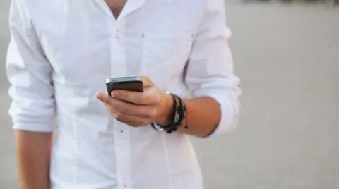 Young caucasian man making a call. Positive guy talking on cellphone and smiling Stock Footage 62313183