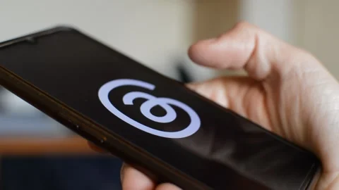 Young caucasian man open threads Meta social network app on his phone. Stock Footage 258930805