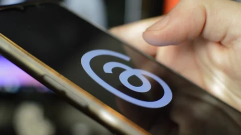 Young caucasian man open threads Meta social network app on his phone. Stock Footage 258930874