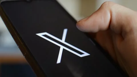 Young caucasian man open twitter x social network app on his phone. Stock Footage 258929300