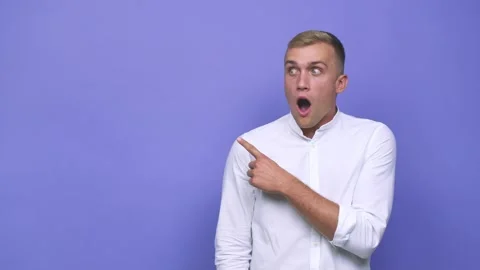 Young caucasian man pointing to the side Stock Footage 140019884