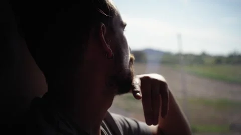 Young Caucasian man sitting riding inside a train, looking pensive and quietly Stock Footage 271073448