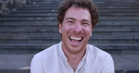 Young caucasian man smiling on camera in the city Stock Footage 158223130