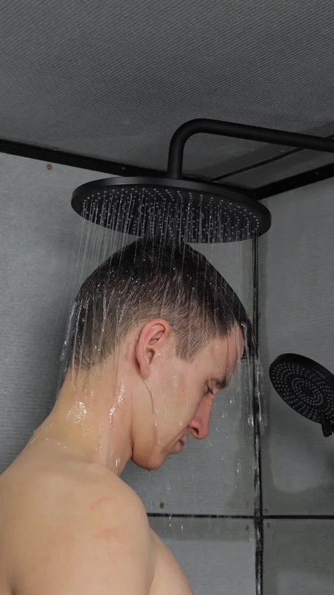 Young caucasian man taking a refreshing morning shower in a modern bathroom Stock Footage 342905755
