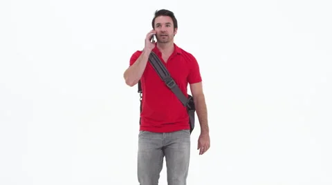 Young caucasian man talking on cellphone and walking Stock Footage 67355482