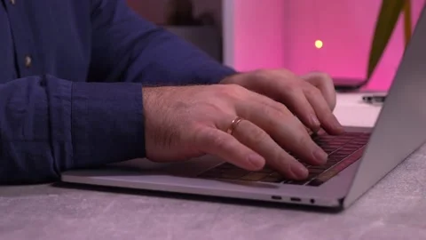 Young Caucasian man is typing something on a laptop keyboard. Stock Footage 162411355