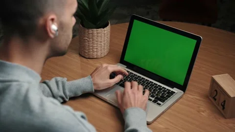 Young caucasian Man using a Laptop Green screen on the desk at home. Stock Footage 144067577