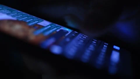 Young caucasian man using phone in the dark Stock-Footage 201409269