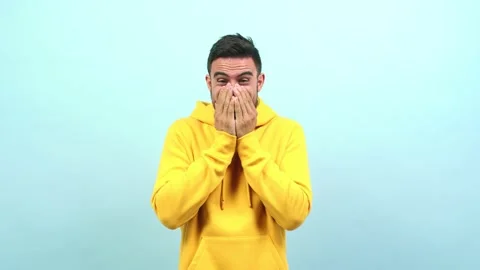 Young caucasian man very scared and afraid, desperate for something, covering Stock Footage 138663085