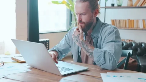 Young Caucasian man works as programmer typing code on laptop for new software Stock Footage 213313701