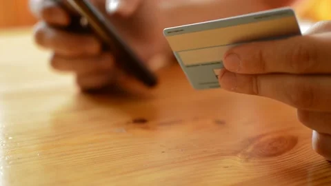 Young caucasian man's hand using credit card for amazon payment on phone. Stock Footage 206045382