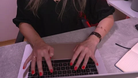 Young Caucasian married woman is typing something on a laptop keyboard. Stock Footage