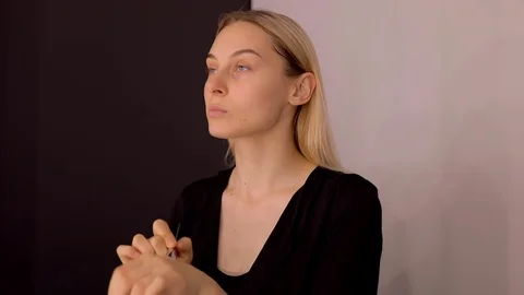 Young caucasian model applying professional makeup. beautiful woman applying Stock Footage 113807846
